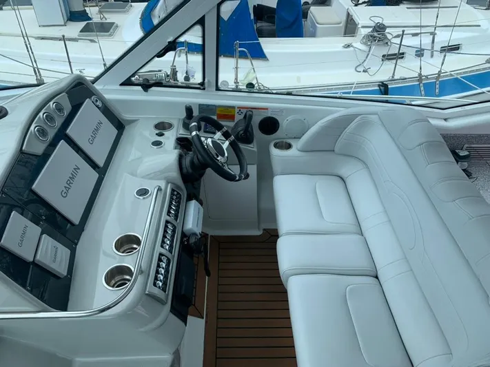 Bella Blue Yacht Photos Pics 2010 Formula 45 yacht cockpit with white seating and Garmin navigation system.