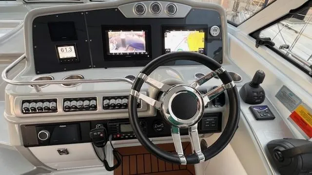 Bella Blue Yacht Photos Pics Steering console of a 2010 Formula 45 boat with modern navigation displays.
