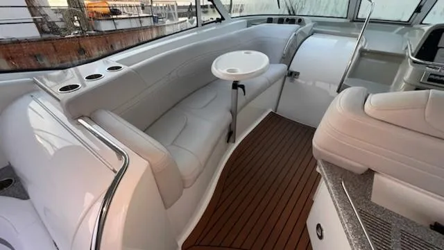 Bella Blue Yacht Photos Pics Luxurious interior of 2010 Formula 45 yacht with white seating and wood flooring.