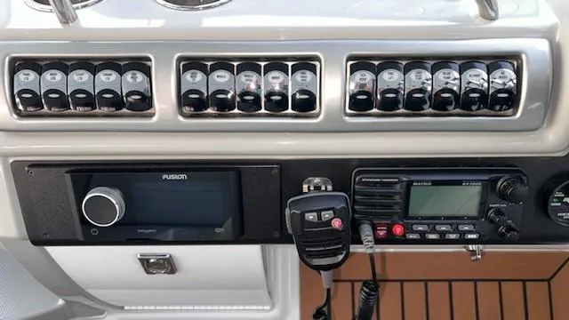 Bella Blue Yacht Photos Pics Control panel of a 2010 Formula 45 boat with switches and communication devices.