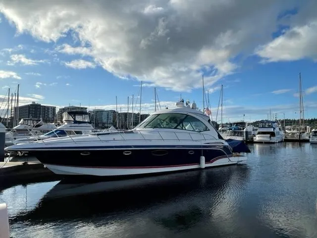 Bella Blue Yacht Photos Pics 2010 Formula 45 yacht docked in marina under cloudy sky.