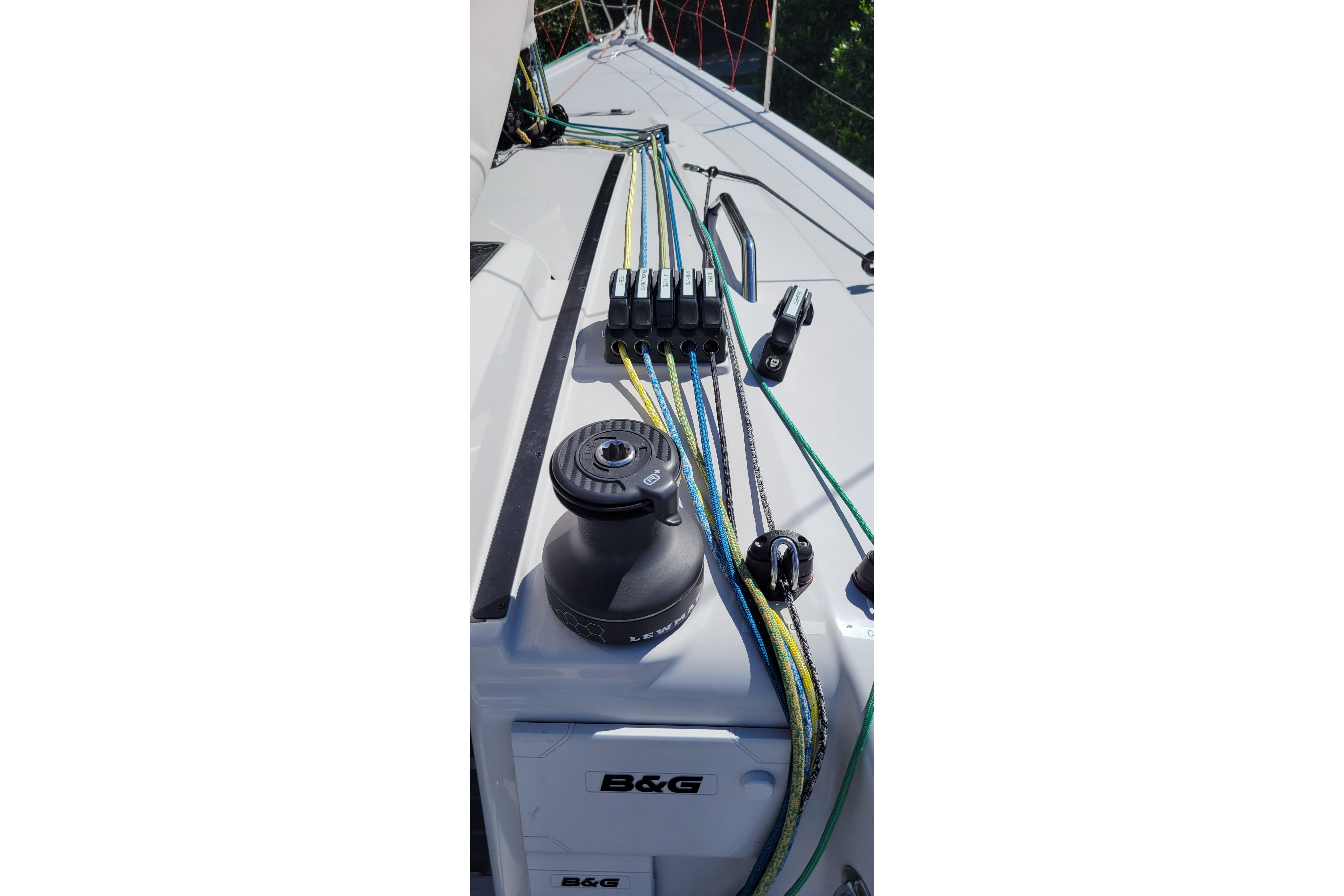 Dehler 30 OD 2020 sailboat deck with winch and colorful ropes.