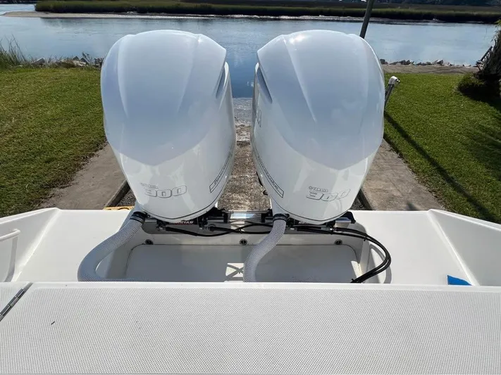  Yacht Photos Pics Twin outboard engines on a 2013 Jupiter 30 FS boat by the water.