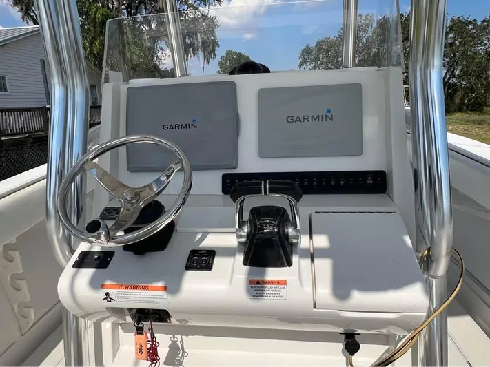  Yacht Photos Pics 2013 Jupiter 30 FS boat console with Garmin navigation displays and steering wheel.