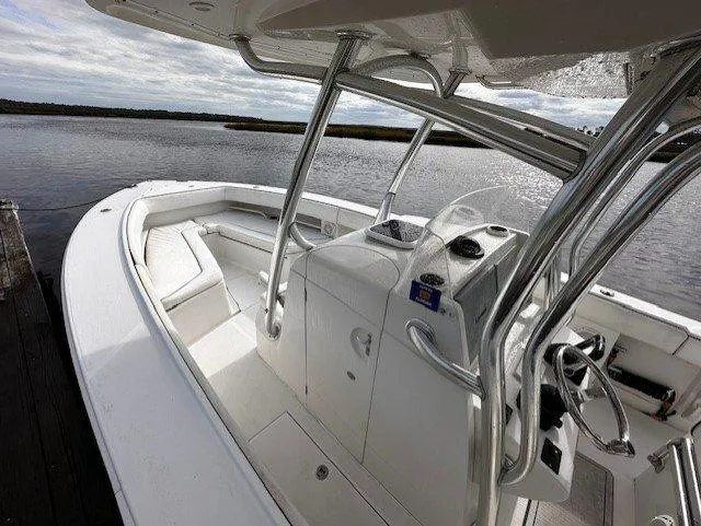  Yacht Photos Pics 2013 Jupiter 30 FS boat interior with helm and seating, docked by calm waters.