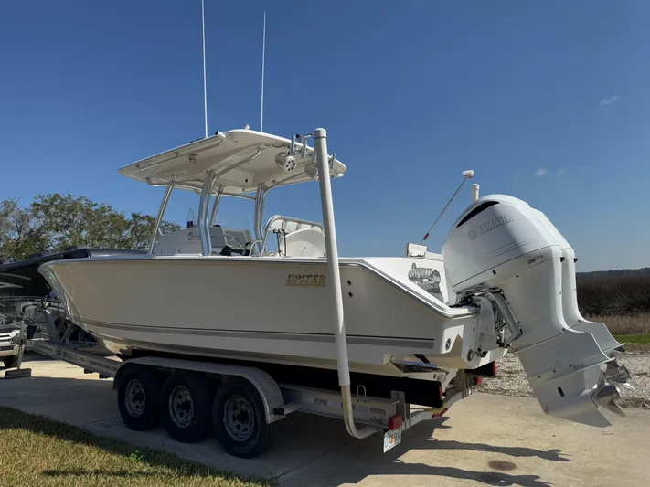  Yacht Photos Pics 2013 Jupiter 30 FS boat on trailer with outboard motor, parked outdoors.