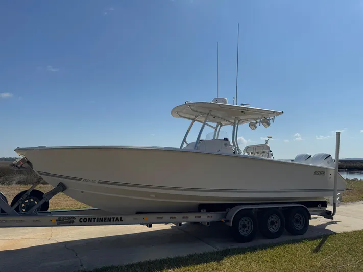  Yacht Photos Pics 2013 Jupiter 30 FS boat on trailer under clear sky.