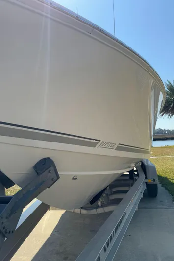  Yacht Photos Pics 2013 Jupiter 30 FS boat on trailer, side view, near water.