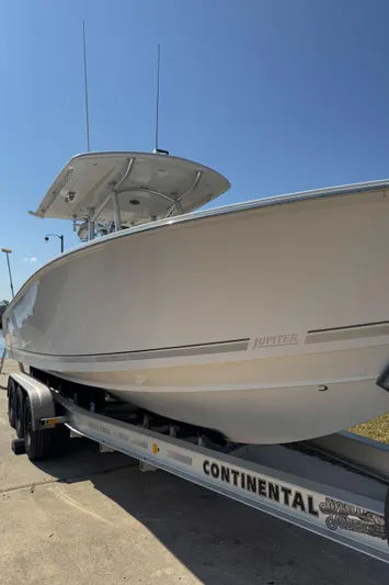  Yacht Photos Pics 2013 Jupiter 30 FS boat on Continental trailer under clear blue sky.