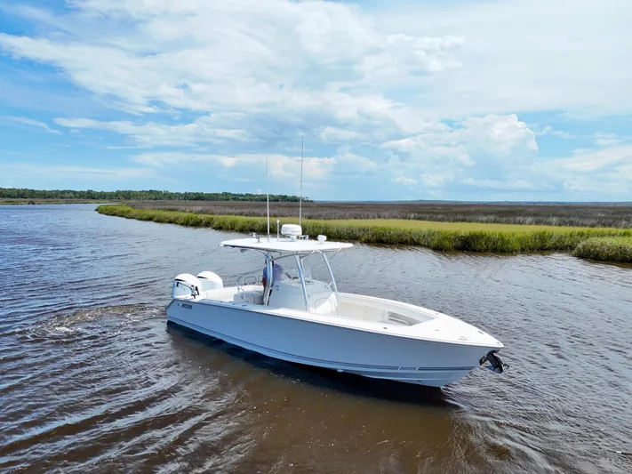  Yacht Photos Pics 2013 Jupiter 30 FS boat cruising on a scenic river under a blue sky.