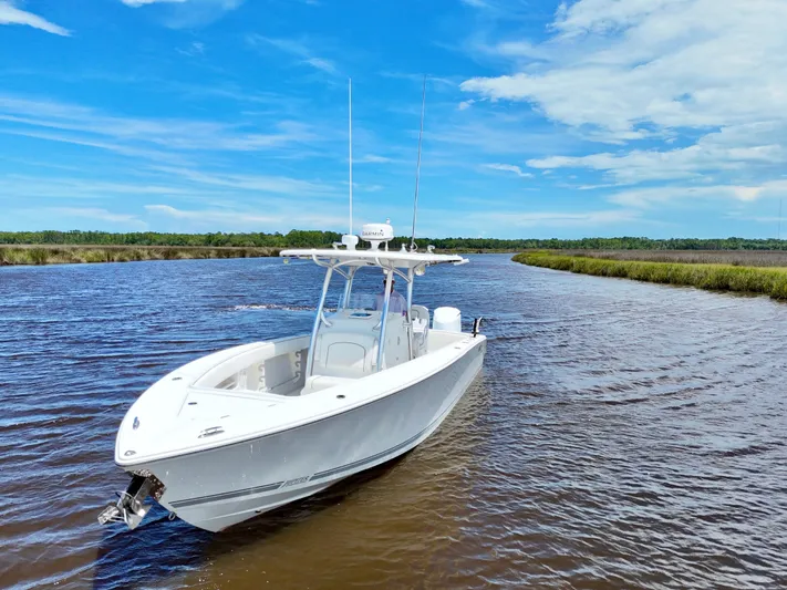  Yacht Photos Pics 2013 Jupiter 30 FS boat on a scenic river under a clear blue sky.