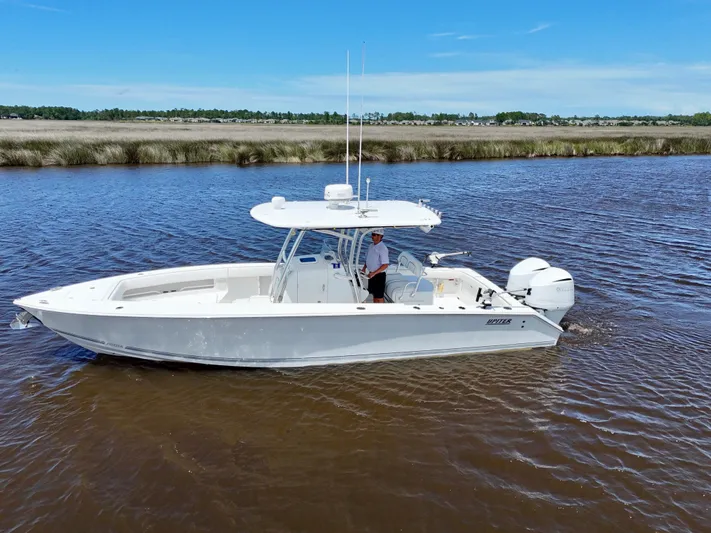  Yacht Photos Pics 2013 Jupiter 30 FS boat cruising on a calm river under a clear blue sky.