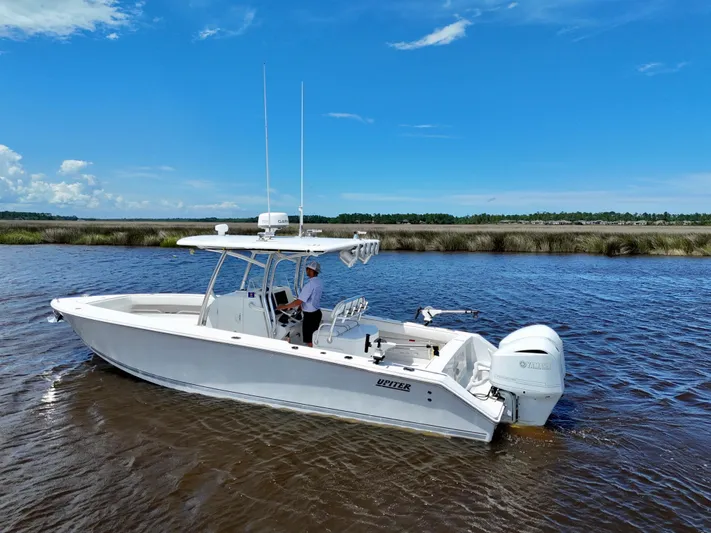  Yacht Photos Pics 2013 Jupiter 30 FS boat cruising on a calm river under a clear blue sky.