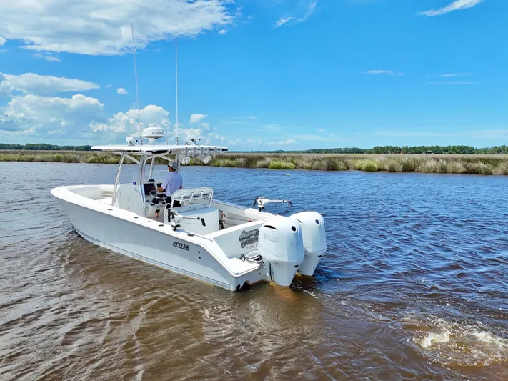  Yacht Photos Pics 2013 Jupiter 30 FS boat cruising on a sunny day in a scenic waterway.