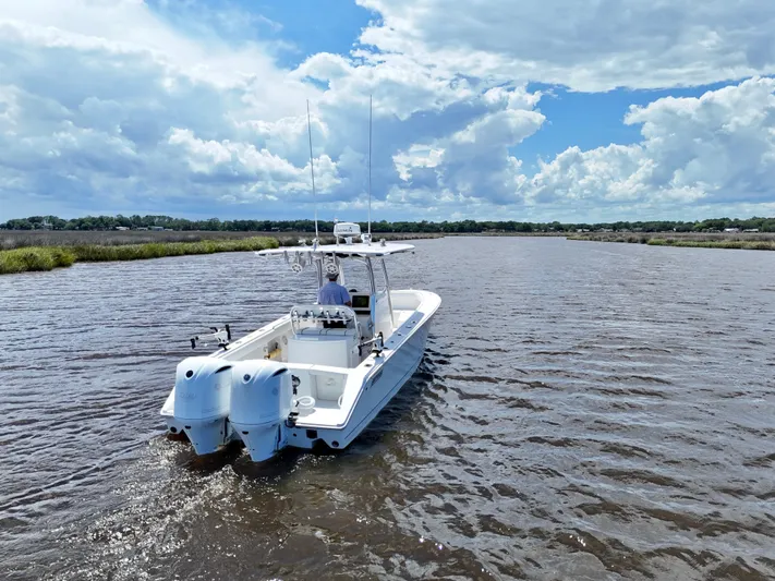  Yacht Photos Pics 2013 Jupiter 30 FS boat cruising on a scenic river under a cloudy sky.
