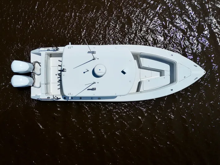  Yacht Photos Pics Aerial view of 2013 Jupiter 30 FS boat on water, showcasing sleek design and twin engines.