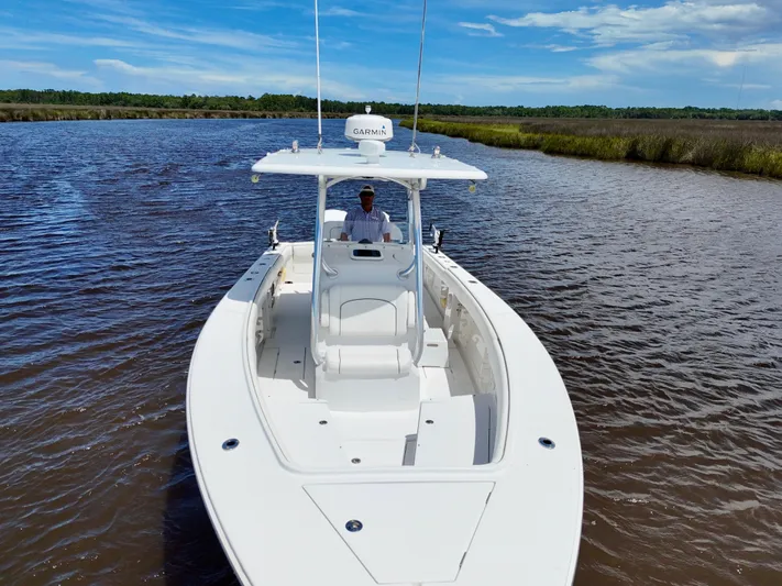  Yacht Photos Pics 2013 Jupiter 30 FS boat cruising on a scenic river under a clear blue sky.