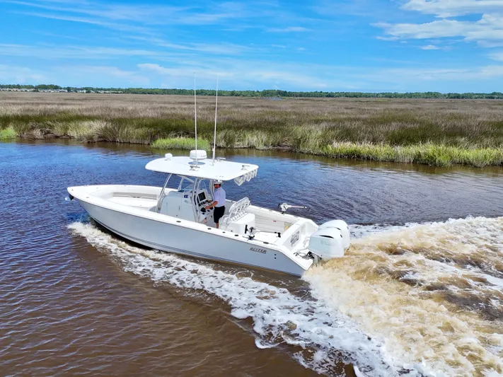  Yacht Photos Pics 2013 Jupiter 30 FS boat cruising on a river under a clear blue sky.