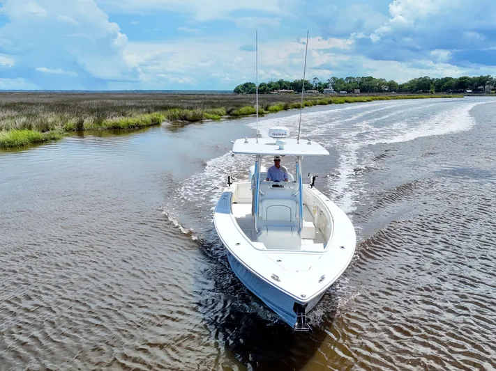  Yacht Photos Pics 2013 Jupiter 30 FS boat cruising on a scenic waterway under a blue sky.