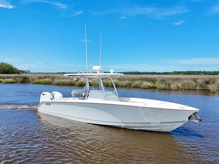  Yacht Photos Pics 2013 Jupiter 30 FS boat cruising on a calm river under a clear blue sky.