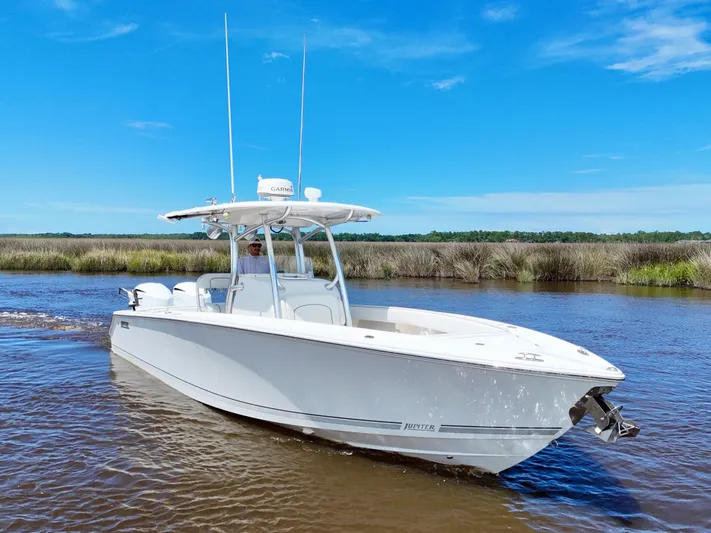 Yacht Photos Pics 2013 Jupiter 30 FS boat cruising on a sunny day in a scenic waterway.