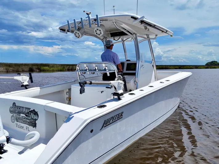  Yacht Photos Pics 2013 Jupiter 30 FS boat on water, clear sky, person steering.