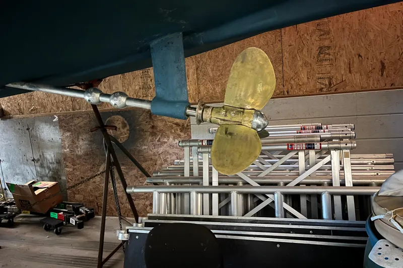 Thumper Yacht Photos Pics Propeller of 2001 Tartan 3700 Sloop in a workshop with ladders and tools.