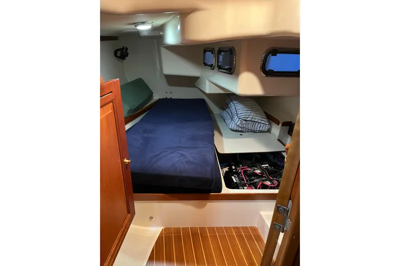 Thumper Yacht Photos Pics Interior cabin of 2001 Tartan 3700 Sloop with bed and storage compartments.