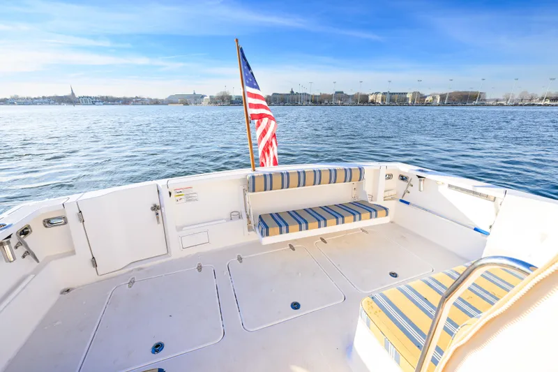 More Mojo Yacht Photos Pics 2009 Sabre 42 Hard Top Express boat deck with striped seating and American flag.