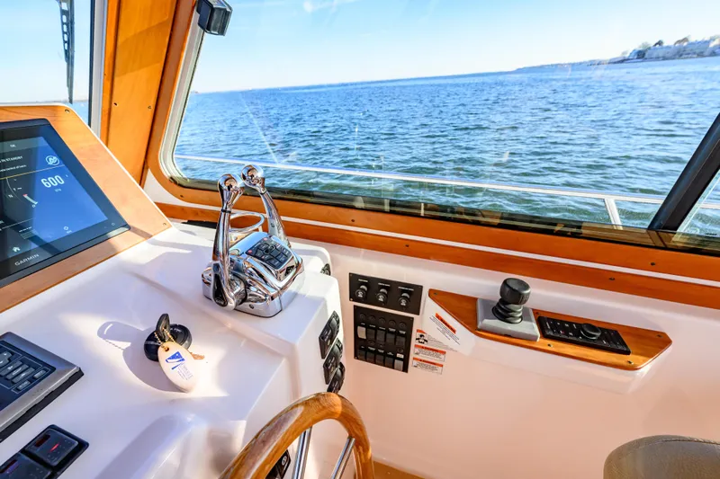 More Mojo Yacht Photos Pics 2009 Sabre 42 Hard Top Express helm with navigation controls and ocean view.