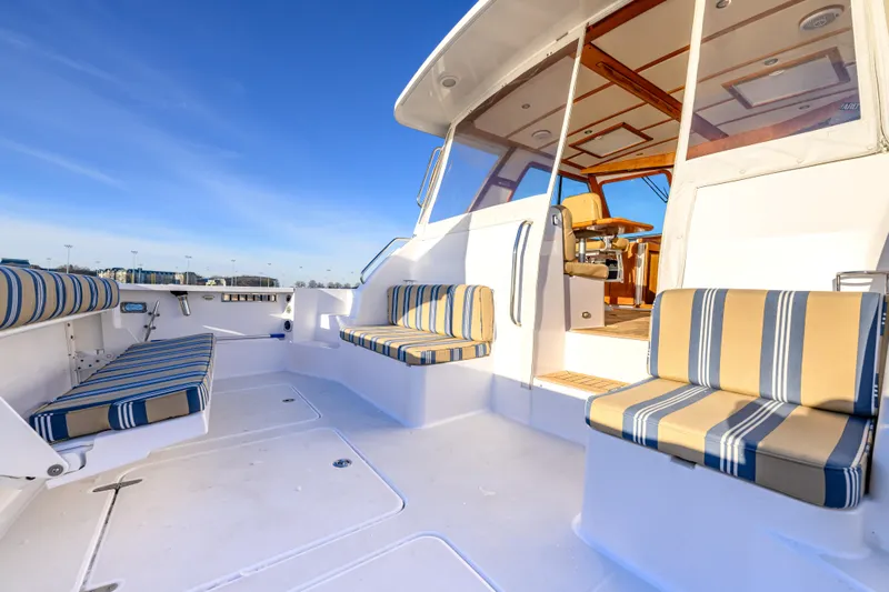 More Mojo Yacht Photos Pics 2009 Sabre 42 Hard Top Express yacht with striped seating and spacious deck under clear sky.