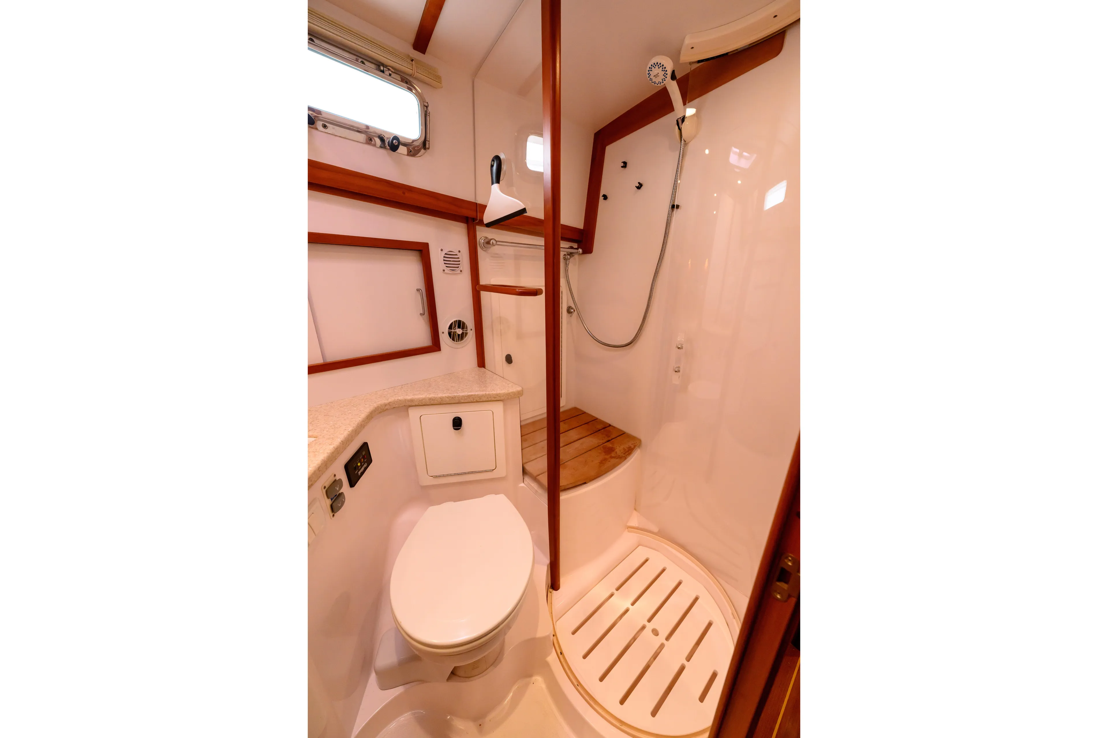 More Mojo Yacht Photos Pics 2009 Sabre 42 Hard Top Express yacht bathroom with shower, toilet, and wooden accents.