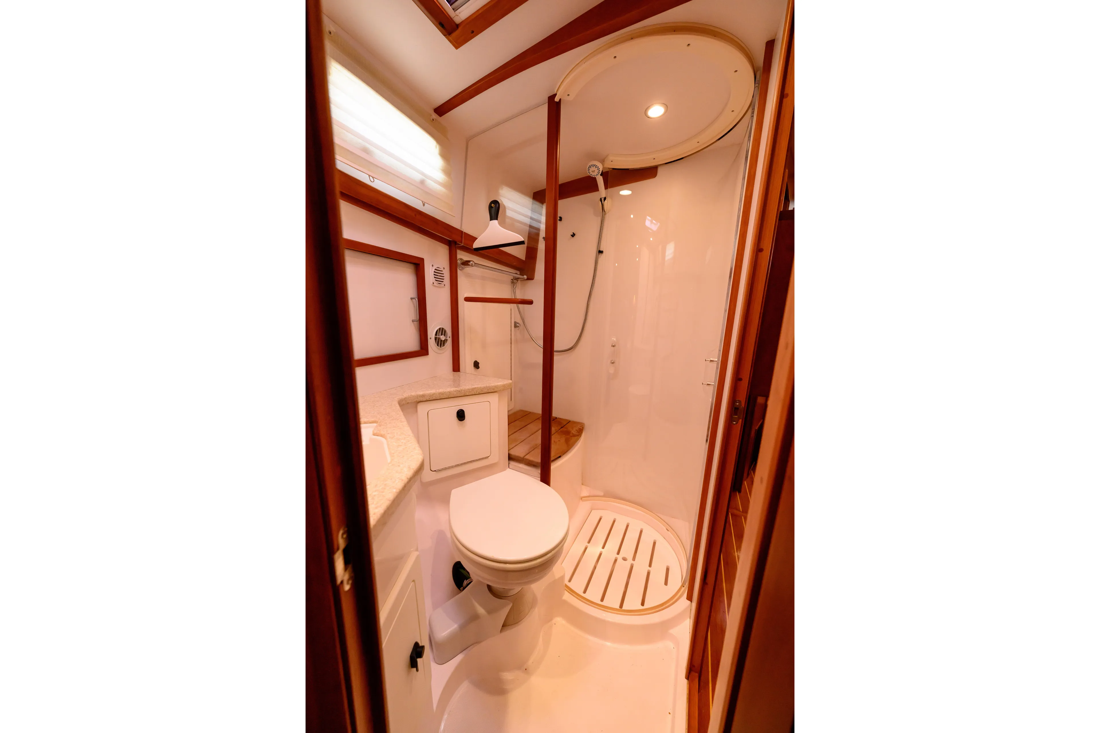 More Mojo Yacht Photos Pics 2009 Sabre 42 Hard Top Express yacht bathroom with shower, toilet, and wooden accents.