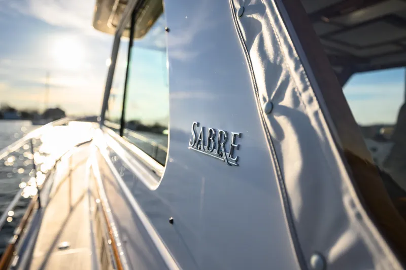 More Mojo Yacht Photos Pics 2009 Sabre 42 Hard Top Express yacht with sunlit exterior and logo detail.