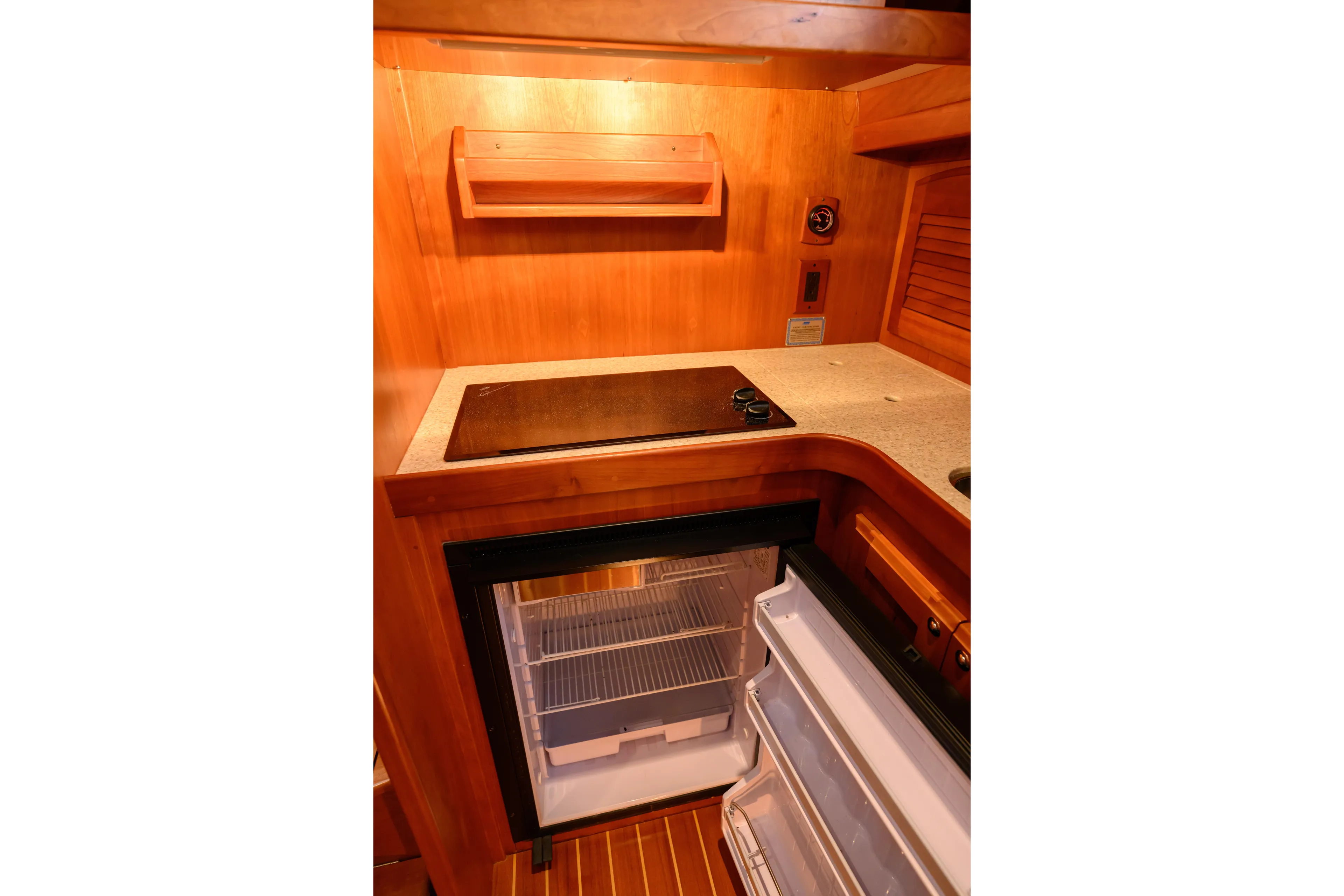 More Mojo Yacht Photos Pics 2009 Sabre 42 Hard Top Express galley with stove and open refrigerator.