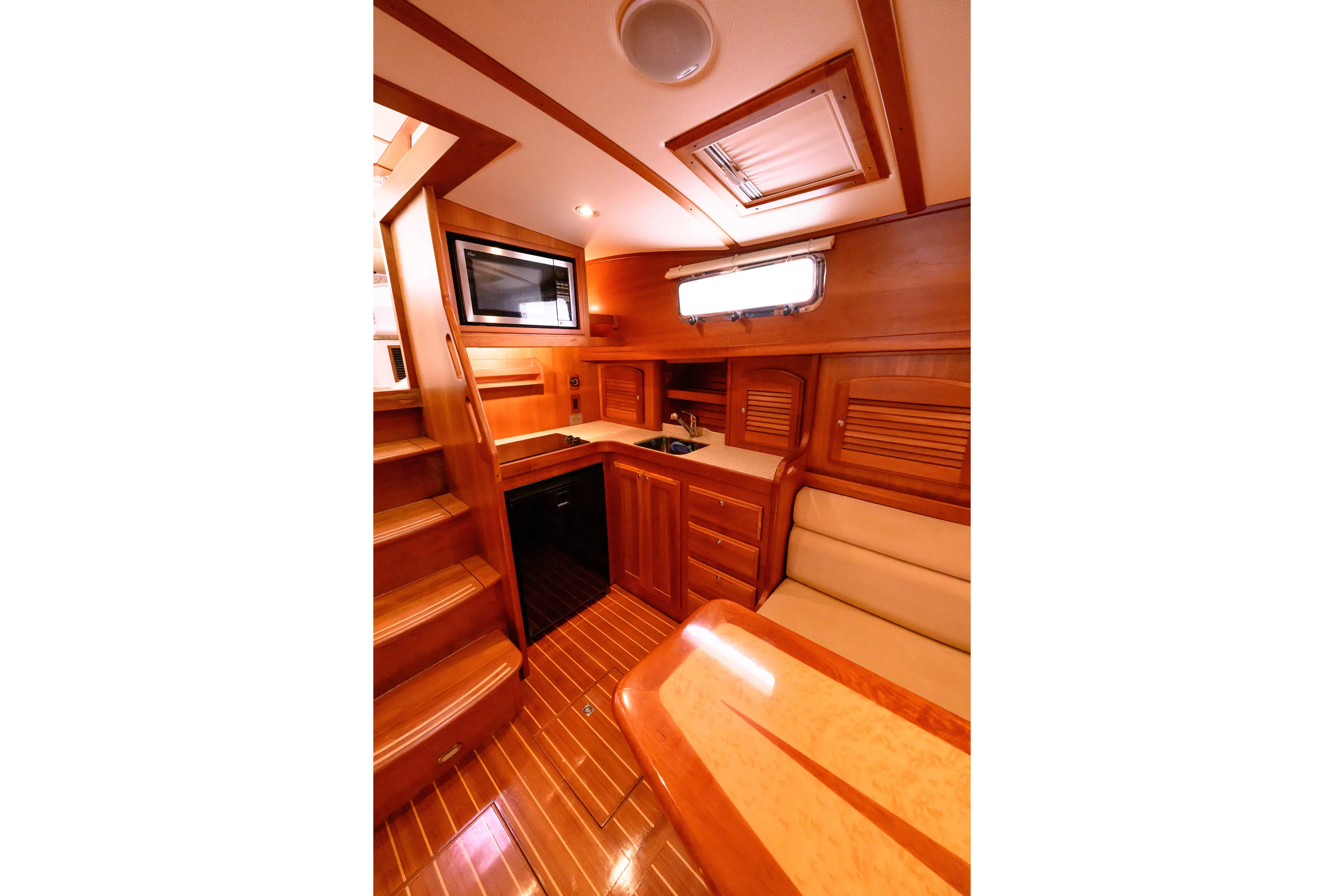 More Mojo Yacht Photos Pics 2009 Sabre 42 Hard Top Express interior with wooden cabinetry, seating, and kitchenette.
