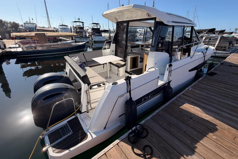 Yacht Photos Pics 2020 Jeanneau NC 895 boat docked at marina with twin engines and spacious deck.
