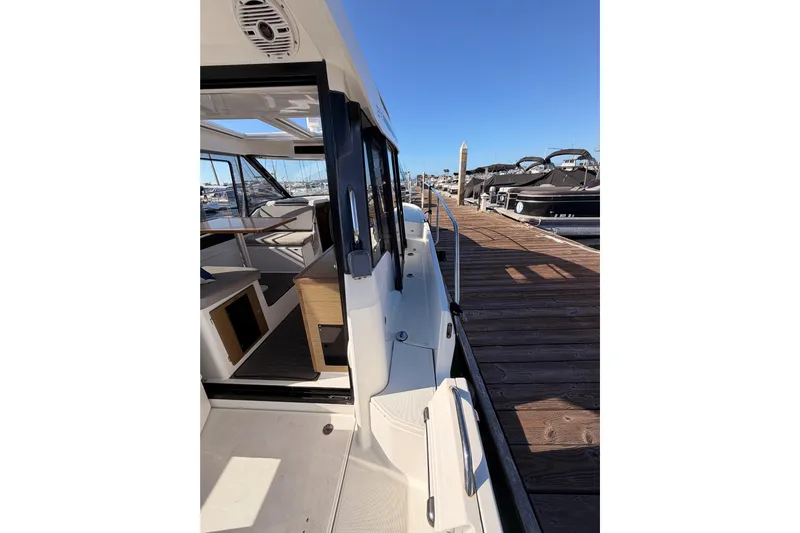  Yacht Photos Pics 2020 Jeanneau NC 895 docked, showcasing sleek design and spacious interior.