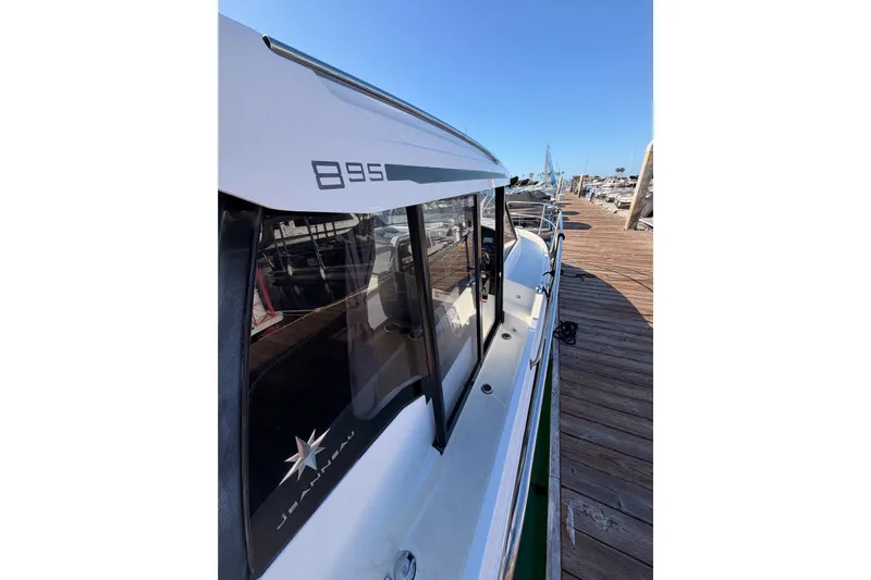  Yacht Photos Pics 2020 Jeanneau NC 895 boat docked, showcasing sleek design and branding.