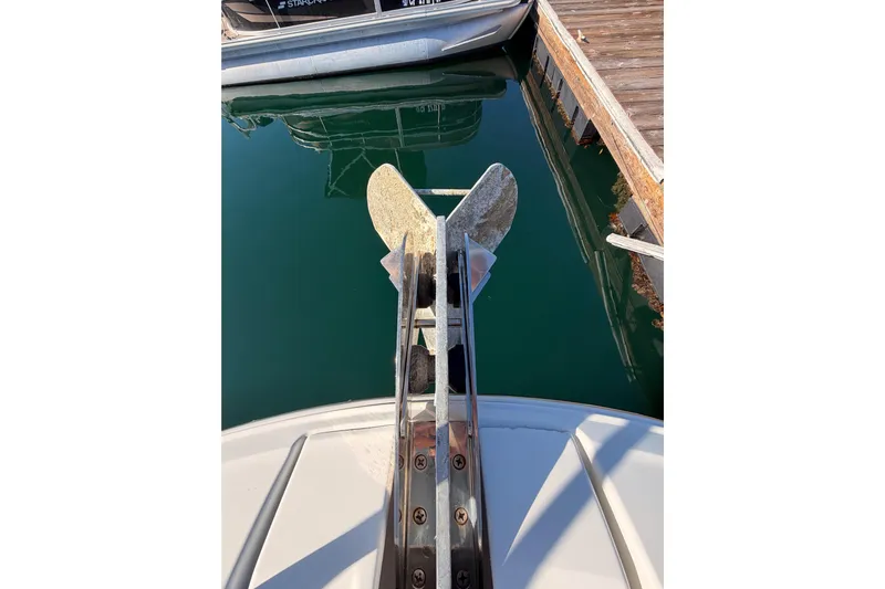  Yacht Photos Pics Bow view of 2020 Jeanneau NC 895 with anchor, docked in calm water.
