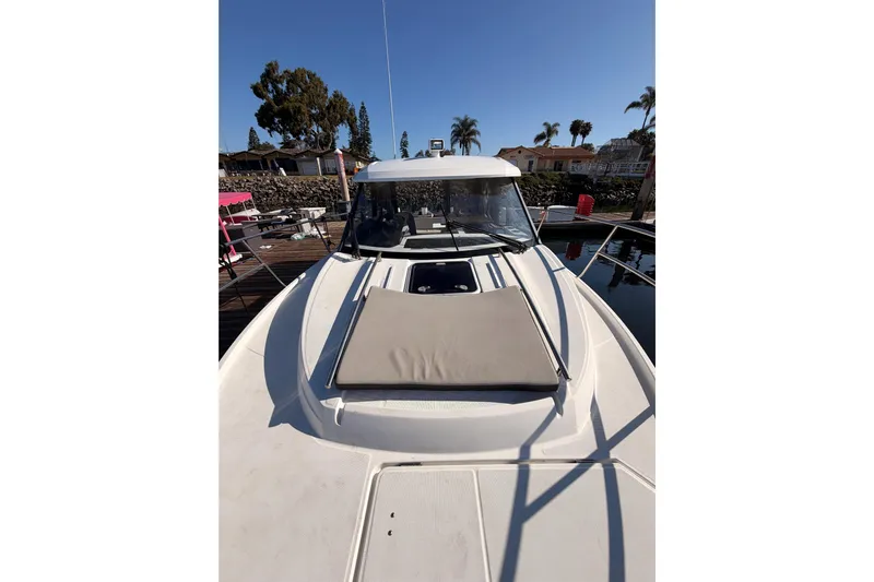  Yacht Photos Pics 2020 Jeanneau NC 895 boat docked, featuring a sunpad on the bow.