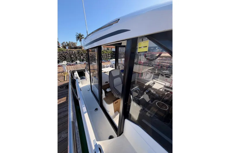  Yacht Photos Pics 2020 Jeanneau NC 895 boat docked, showcasing sleek design and spacious interior.