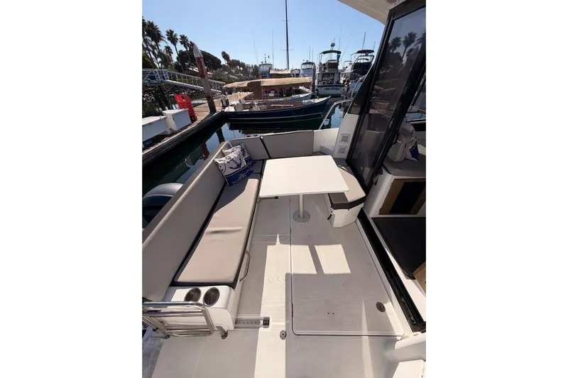  Yacht Photos Pics 2020 Jeanneau NC 895 boat deck with seating and table in marina.