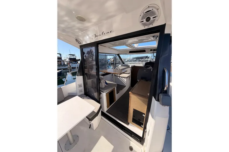  Yacht Photos Pics 2020 Jeanneau NC 895 boat interior with seating and table, docked at marina.