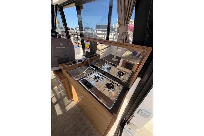  Yacht Photos Pics Interior of 2020 Jeanneau NC 895 boat featuring a compact kitchen area.