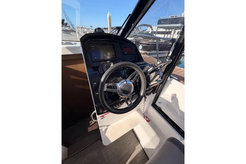 Yacht Photos Pics 2020 Jeanneau NC 895 helm with steering wheel and navigation controls.