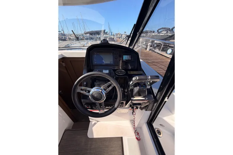  Yacht Photos Pics 2020 Jeanneau NC 895 helm with steering wheel and navigation controls.