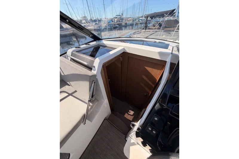 Yacht Photos Pics 2020 Jeanneau NC 895 boat interior with cabin entrance and marina view.
