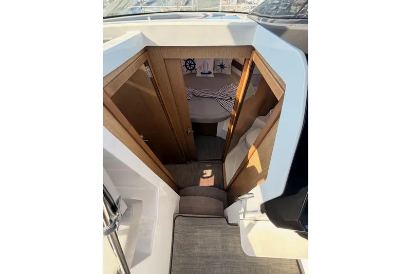  Yacht Photos Pics 2020 Jeanneau NC 895 cabin interior with wooden doors and nautical decor.