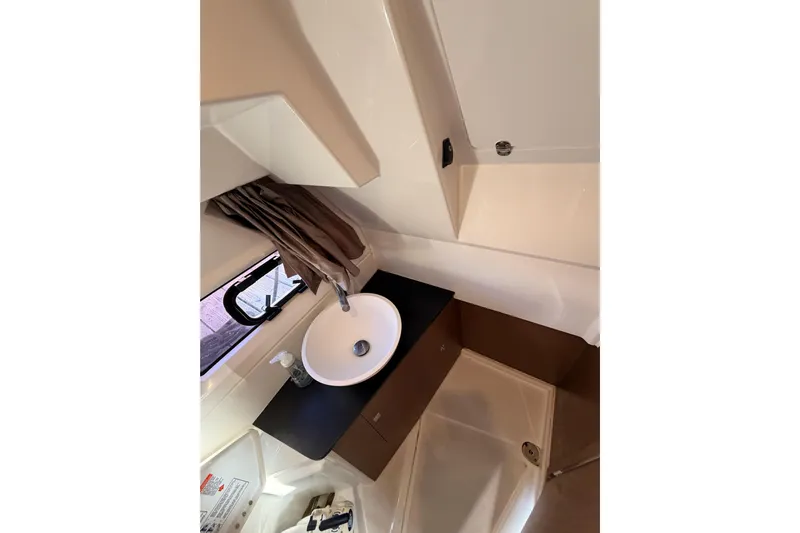  Yacht Photos Pics 2020 Jeanneau NC 895 bathroom interior with sink and window.